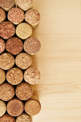 A lot of wine textured wine cork on the wooden background.