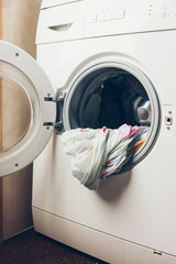 Washing machine with open door. Laundry. Preparing the wash cycle