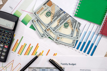 finance concept - money, business graph, pen, notepad, calculator