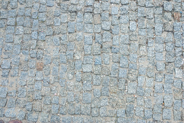 old square stone floor as texture. close up