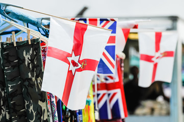 Ulster parliament (defunct) flags and Union flags on sale at a market stall