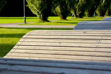 Wooden bench in the form of a wave to stay in the park