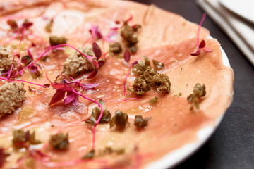 Tuna carpaccio with truffle paste and capers, toned image