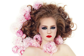 Vintage style portrait of young beautiful girl with stylish make-up and pink flowers in her hair