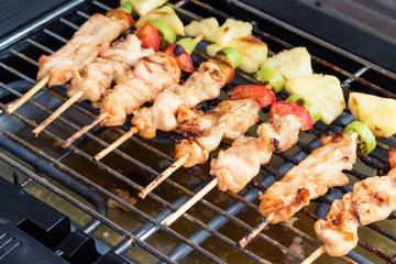 Close Up,Grilled chicken barbecue with bamboo skewers on Electric grill
