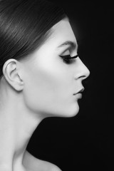 Black and white profile portrait of young beautiful woman with false eyelashes