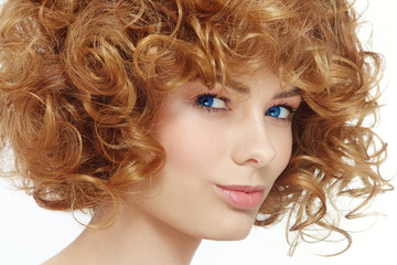 Close-up portrait of young beautiful woman with curly hair