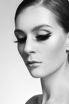 Portrait of young beautiful woman with cat eye make-up and false eyelashes, selective focus