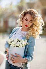 Beautiful woman with paper box of flowers