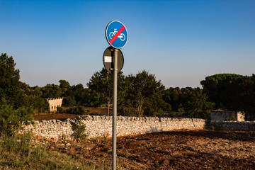 Bike signal post near an aqueduct in italia
