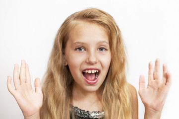 A beautiful young girl expresses emotions surprise, joy
