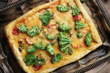 Traditional quiche with broccoli and cheese on tray