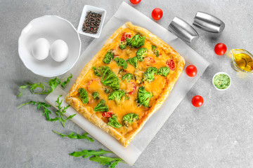 Traditional quiche with broccoli and cheese on table