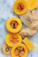 Round slices of pumpkin seeds and pieces of cloth.