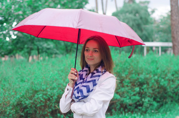 Beautiful young woman on nature park umbrella