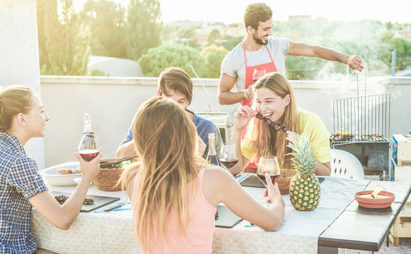 Young Friends Eating And Drinking Red Wine At Rooftop Barbecue Party - Happy People Grilling And Having Fun At Bbq Dinner Outdoor - Main Focus On Right Woman Face - Food, Fun And Friendship Concept