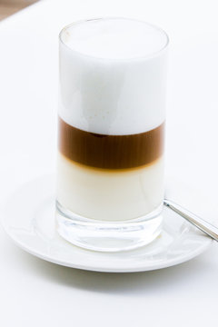 Glass of coffe with milk and milk foam in layers