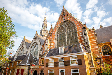 Fototapeta premium Morning view on the Old church in Amsterdam city during the sunny weather