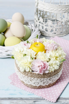 Easter floral arrangement with pink and yellow carnations.