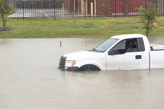 Pickup truck swamped by flood water in Humble, Texas,US by Harvey Tropical Storm. Flooded car under deep on heavy high water road. Disaster Motor Vehicle Insurance Claim Themed. Severe weather concept