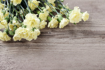 Carnation flowers on wood