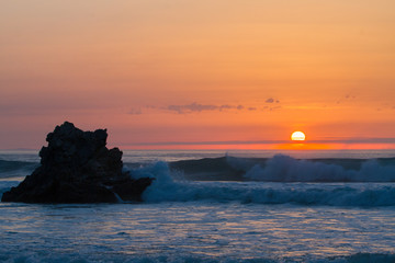 Sunset reflection in the ocean on Arrietara beach, Atxabiribil Sopelana, Basque Country (Euskadi), Spain