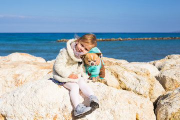 Happy little girl playing with dog