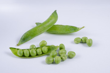 Fresh green pea pod on white background