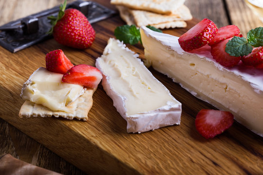 Brie cheese with fresh strawberries and mint