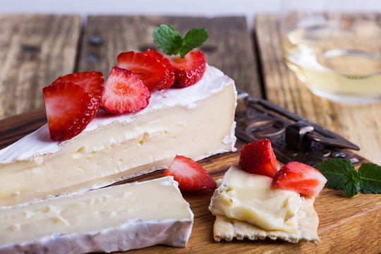 Brie cheese with fresh strawberries and mint