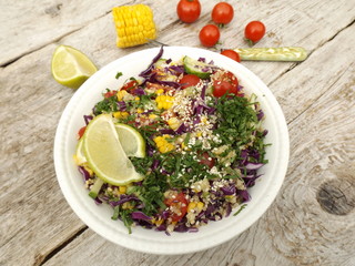 Mixed salad of shredded red cabbage, cucumbers, corn, tomatoes and quinoa.