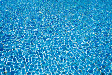 Blue pool water with sun reflections