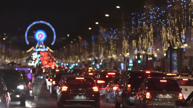 Paris - France - December 2016. Traffic jam on Champs Elysees. Ferris Wheel, Egyptian Obelisk background. Christmas Night light.