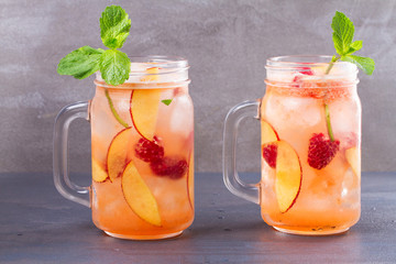 Peach Raspberry Lemonade, Garnished with Mint. Fruit Berry Cocktail in Jars