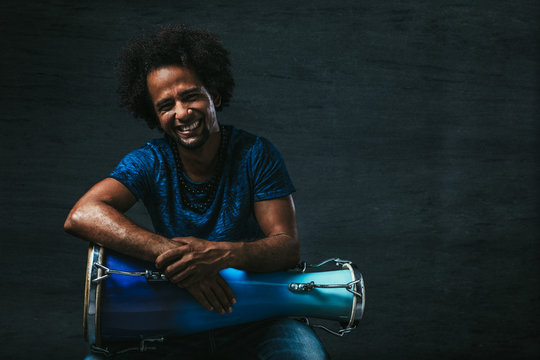 Portrait of a Cuban Musician over Dark Background
