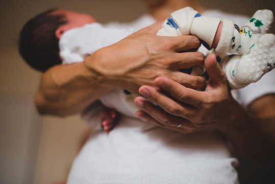 Dad holding newborn baby