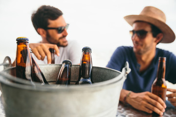 Bucket of beers and friends having some beers in a beach bar