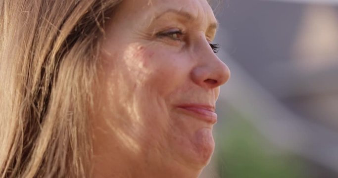 Older women chatting with friends outdoors in summer