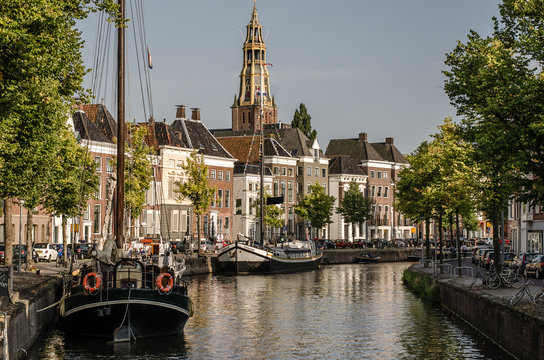 Groningen, Groningen - 22 augustus 2017: View over a canel in Groningen with the A-kerk in the back