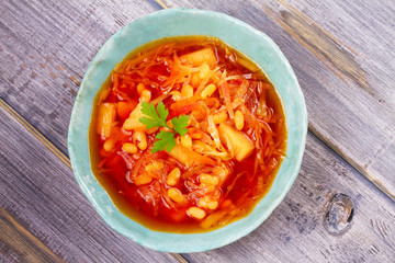 Borsht, bortsch, borshch, borscht. Soup made with vegetables, bean and beet. View from above, top studio shot