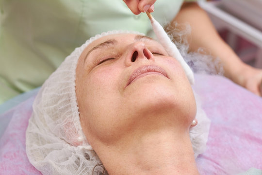 Face cryomassage, close up. Cosmetic liquid nitrogen therapy.