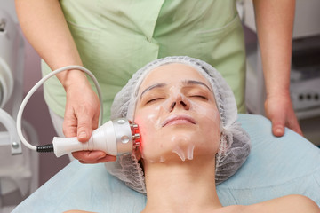 Rf face lift, collagen mask. Young woman undergoing skin treatment. Improving look without surgery.