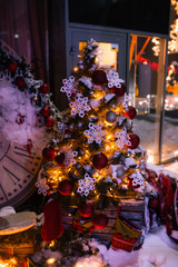 Christmas background with illuminated fir tree and fireplace, clock at house