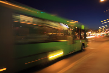 Fototapeta na wymiar Traffic bus on the street late at night with motion blur