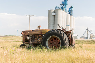 old tractor in front of grain terminal