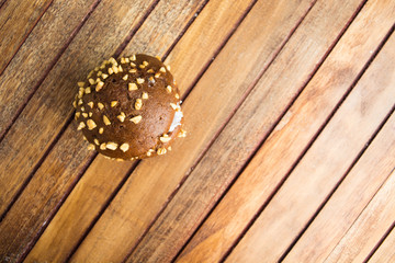 Chocolate cookie with cream and nuts on wooden background