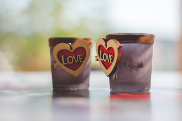 two Love candle holders with heart sign close up
