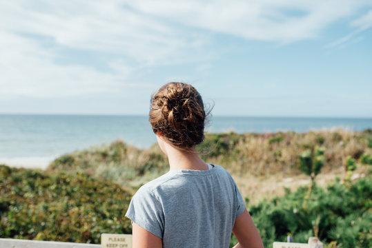 A young woman looking at the sea