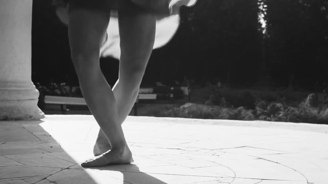 Bare feet of a woman dancing on a stone floor