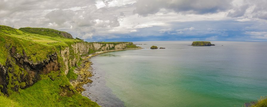 Cliffs of Carrick-a-rede rope bridge in Ballintoy, Co. Antrim. Landscape of Northern Ireland.Traveling through the Causeway Coastal Route. 